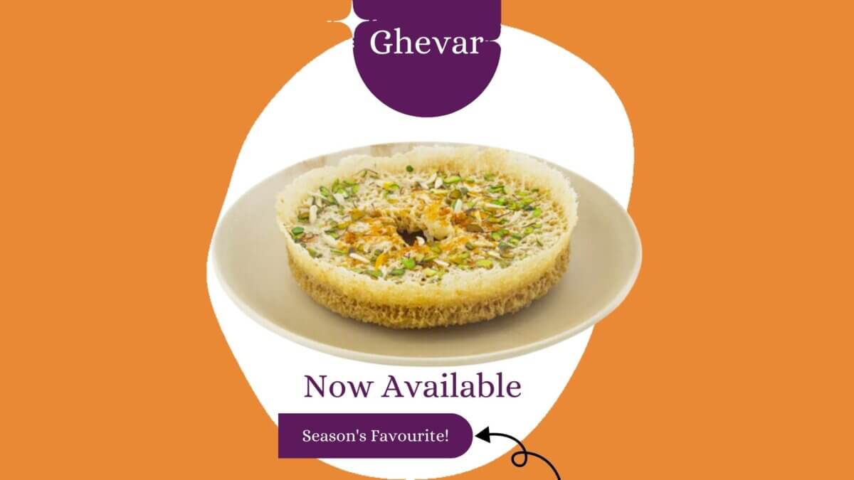 Freshly made Ghevar at Kesar Sweets & Restaurant, a traditional Indian sweet, garnished with dry fruits and edible silver leaf, perfect for the Savan season.